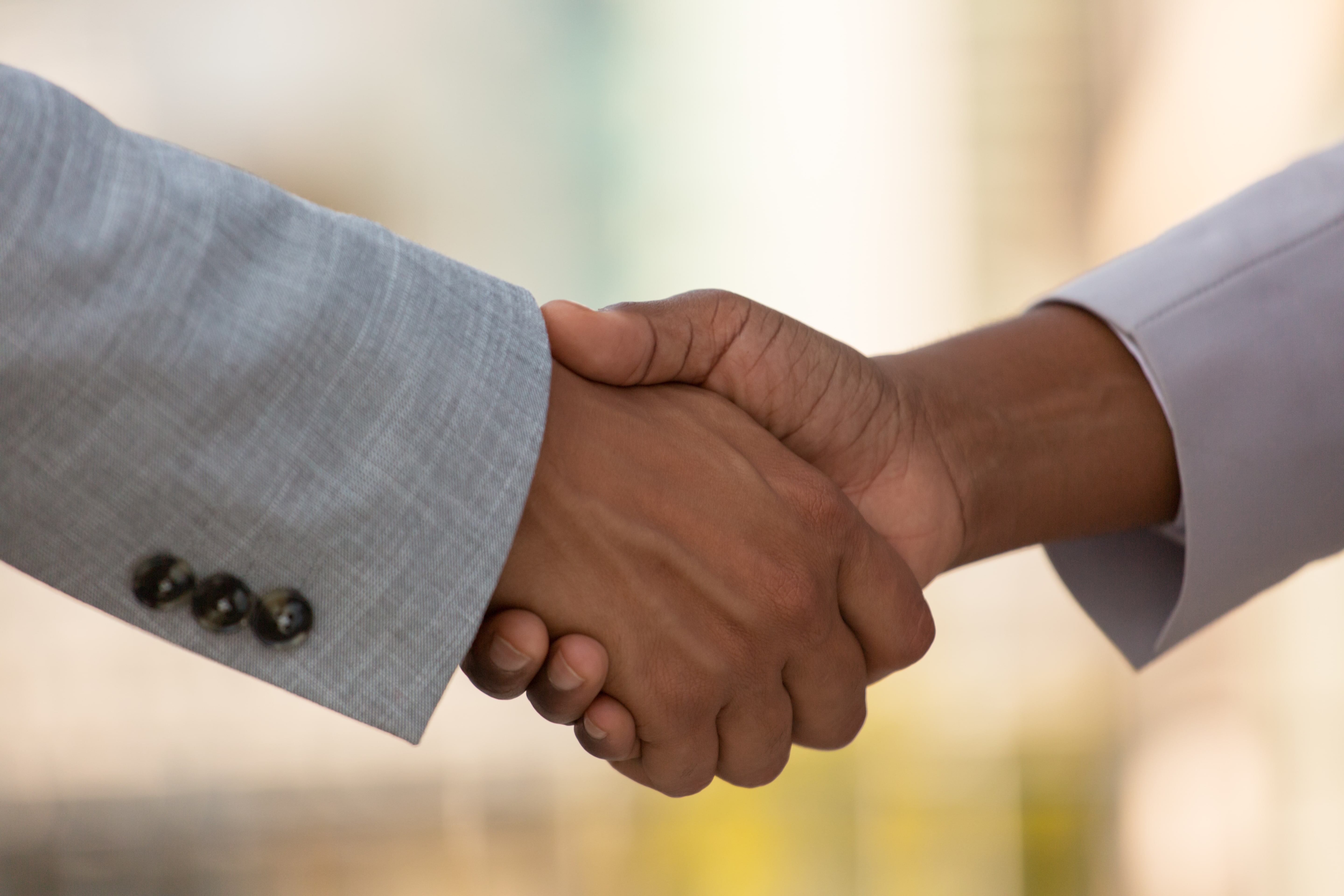 closeup-business-colleagues-handshake-min